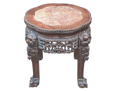 Lot 623 - An early 20th century Chinese carved hardwood table with inset marble top.