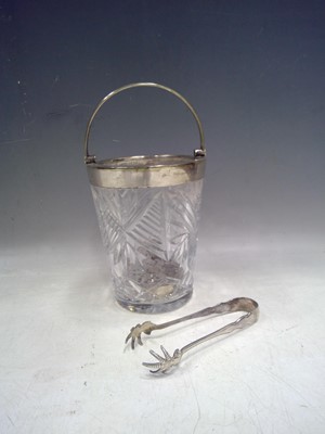 Lot 24 - Antique glass ice bucket with claw tongs. The...