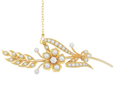 Lot 9 - An Edwardian 15k gold seed pearl and diamond set floral brooch.
