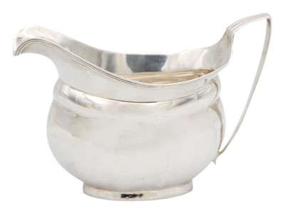Lot 105 - A George III silver cream jug of oval faceted form.