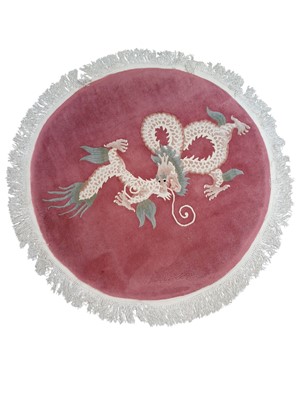 Lot 684 - A pink ground circular washed wool Chinese rug.