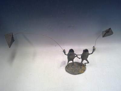 Lot 202 - A garden sculpture of two frogs flying a kite....