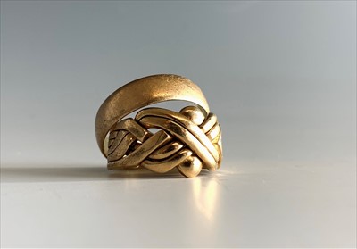 Lot 2475 - A 9ct gold puzzle ring and a 9ct gold band 14.2gm