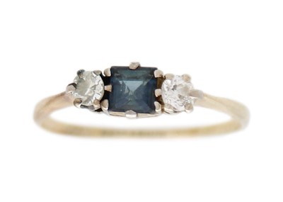 Lot 27 - A gold and palladium three-stone diamond and sapphire ring.
