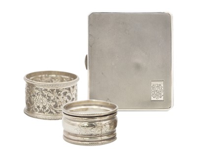Lot 114 - A George V silver engine turned cigarette case by Walker & Hall, and two silver napkin rings.