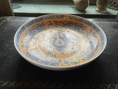 Lot 63 - A Chinese porcelain yellow ground charger.