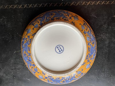 Lot 63 - A Chinese porcelain yellow ground charger.