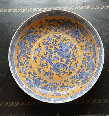 Lot 63 - A Chinese porcelain yellow ground charger.