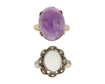 Lot 16 - A gold and amethyst cabochon ring, and a silver with gold opal and marcasites ring.