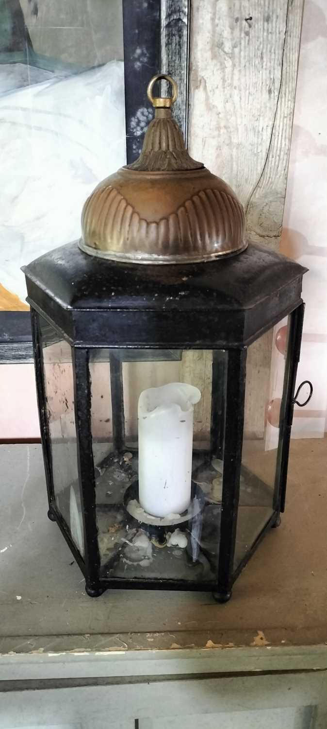 Lot 74 - A brass and painted steel hexagonal glazed candle lantern.