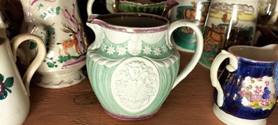 Lot 82 - A shelf of predominantly Victorian pottery jugs.