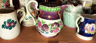Lot 82 - A shelf of predominantly Victorian pottery jugs.