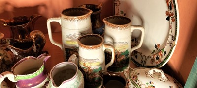 Lot 82 - A shelf of predominantly Victorian pottery jugs.