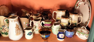 Lot 82 - A shelf of predominantly Victorian pottery jugs.