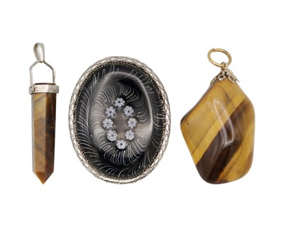 Lot 56 - Two tiger's eye pendants and a silver enamel brooch.