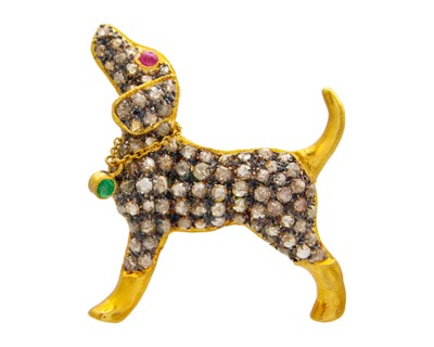 Lot 44 - An antique style silver gilt, emerald, ruby, and diamond set hound brooch/pendant.