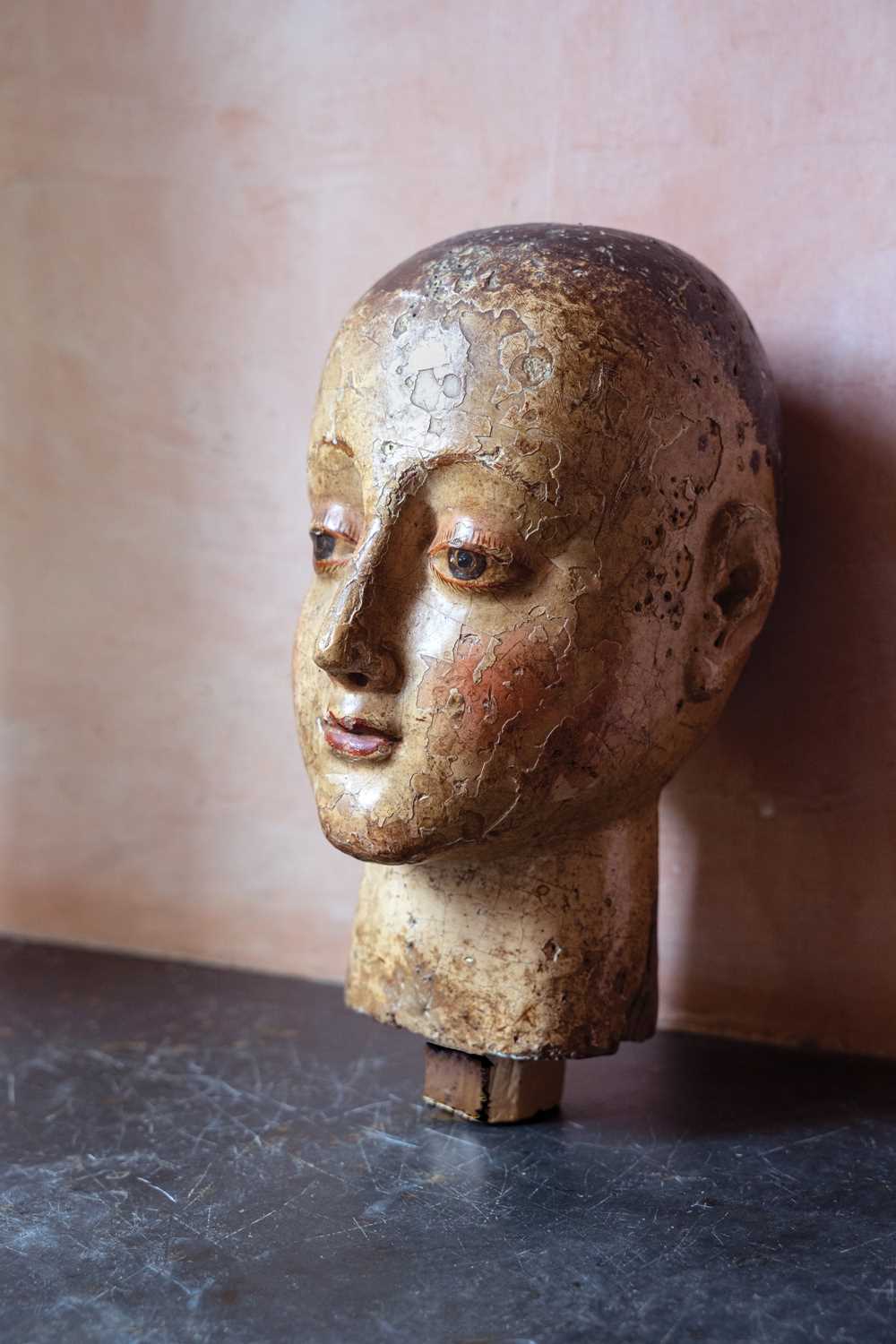 Lot 99 - A carved and gesso head of a saint.