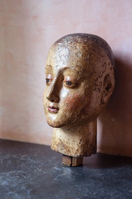 Lot 99 - A carved and gesso head of a saint.
