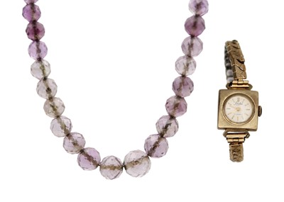 Lot 35 - A 9k gold lady's wristwatch and a faceted amethyst bead necklace.