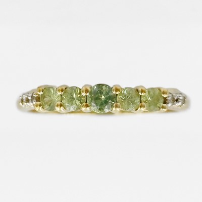 Lot 166 - A 9k gold graduated five-stone peridot and diamond ring.