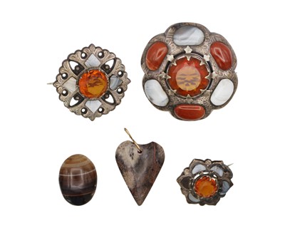 Lot 95 - A selection of three Scottish silver and agate brooches with a hardstone pendant.