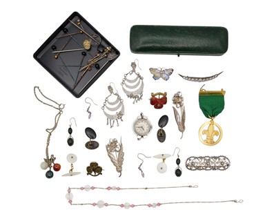 Lot 12 - An assortment of costume jewellery, badges, pins, and one lady's wristwatch.