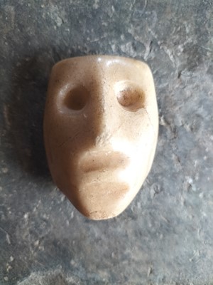 Lot 123 - A white marble face.