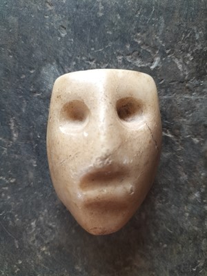 Lot 123 - A white marble face.