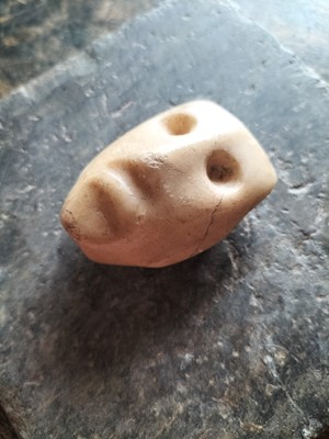 Lot 123 - A white marble face.