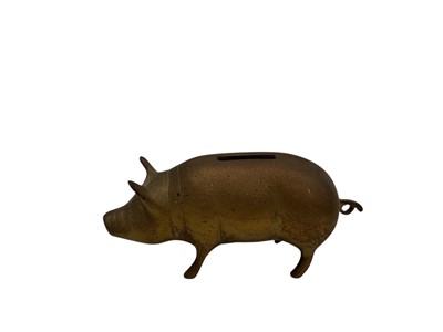 Lot 60 - A brass piggy bank, height 8.5cm x length 19cm.