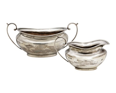 Lot 144 - A George V silver cream jug and sugar bowl by Barker Brothers.