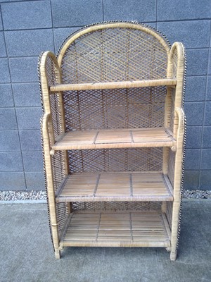 Lot 34 - A Cane and Raffia Shelve Unit. The size is...