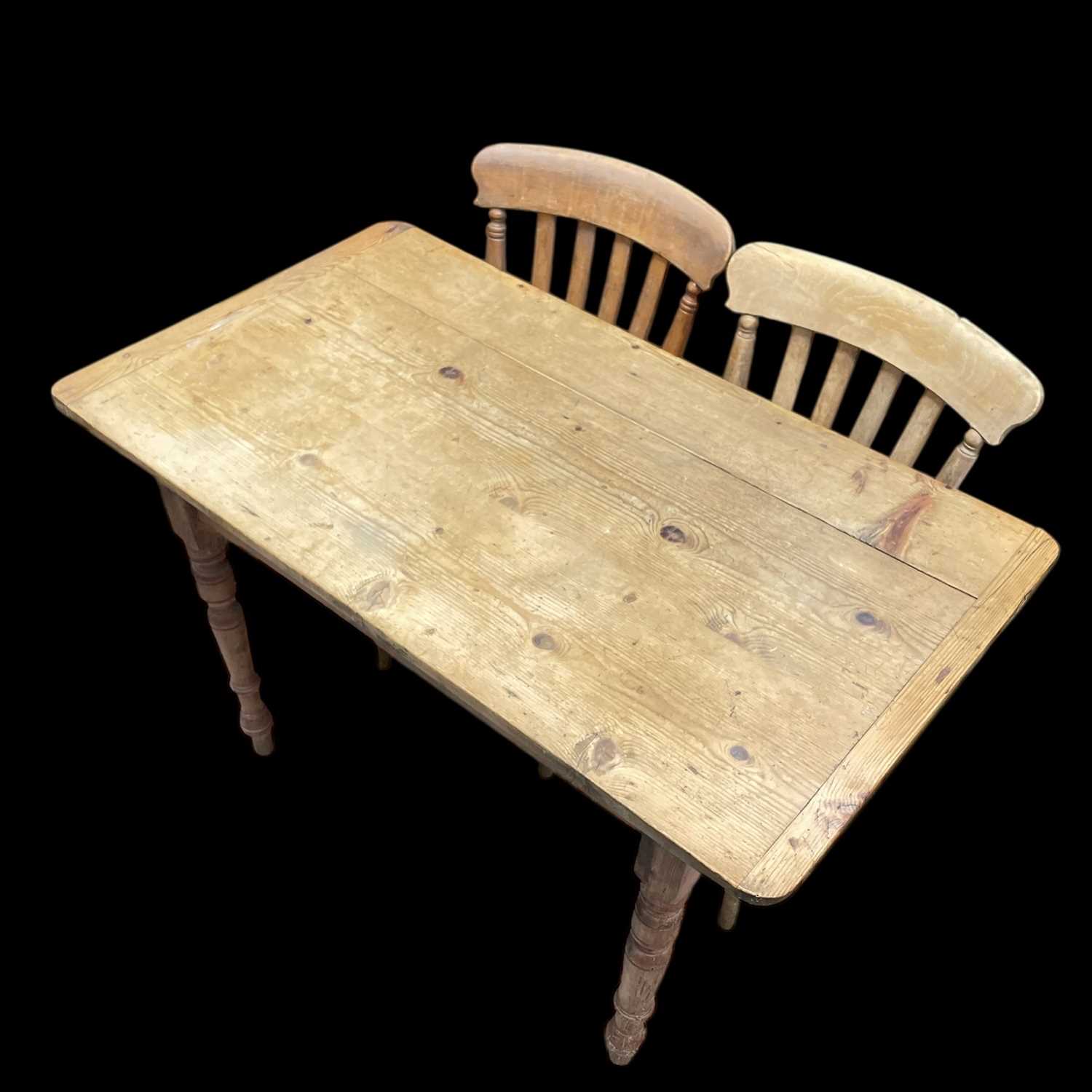 Lot 9 - A Pine Kitchen Table and Two Chairs. The Table