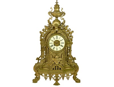 Lot 805 - An ornate French brass mantel clock.