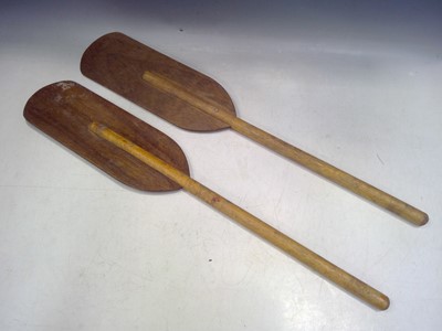 Lot 70 - Two Paddles and an Oar Hanger. The Paddles are...