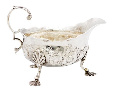 Lot 88 - A George II silver sauce boat with foliate embossed decoration.