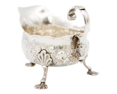 Lot 88 - A George II silver sauce boat with foliate embossed decoration.