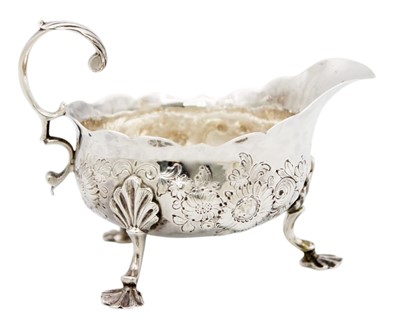 Lot 88 - A George II silver sauce boat with foliate embossed decoration.