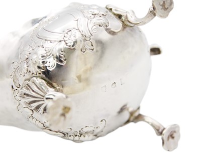 Lot 88 - A George II silver sauce boat with foliate embossed decoration.