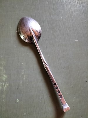 Lot 132 - Omar Ramsden, an Arts and Crafts silver preserve spoon.