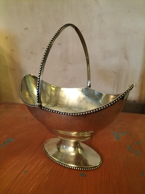 Lot 136 - A George III silver oval swing handled basket.