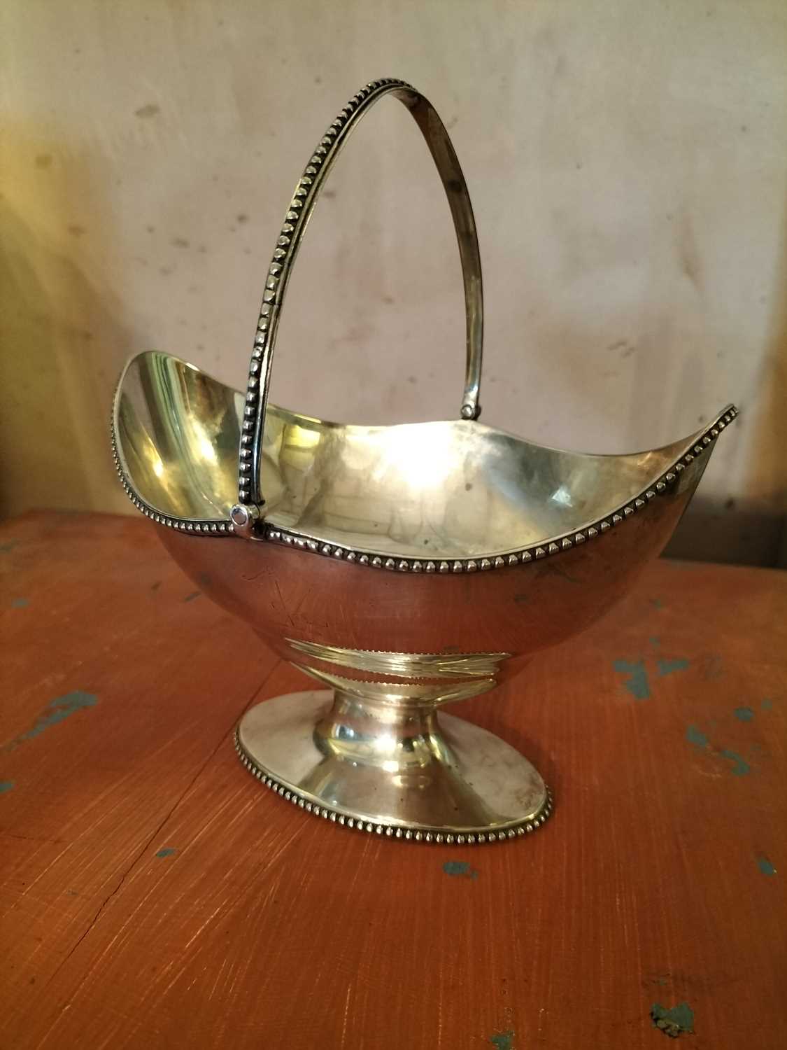 Lot 136 - A George III silver oval swing handled basket.