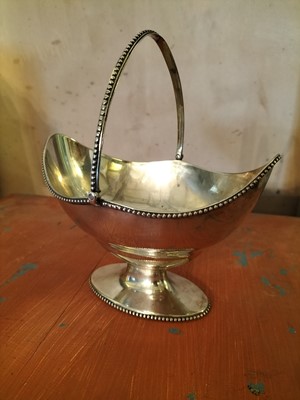 Lot 136 - A George III silver oval swing handled basket.