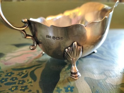Lot 138 - A matched pair of late Victorian silver sauceboats.