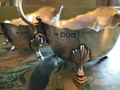 Lot 138 - A matched pair of late Victorian silver sauceboats.