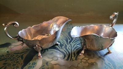 Lot 138 - A matched pair of late Victorian silver sauceboats.