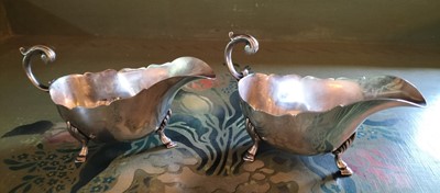 Lot 138 - A matched pair of late Victorian silver sauceboats.