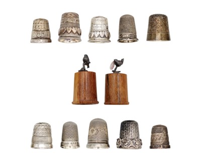 Lot 166 - A collection of ten silver thimbles and a pair of novelty treen thimbles.
