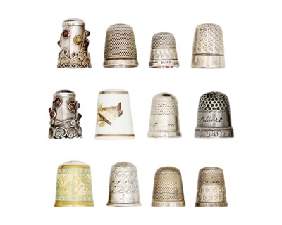 Lot 170 - A collection of silver thimbles, including two in porcelain.