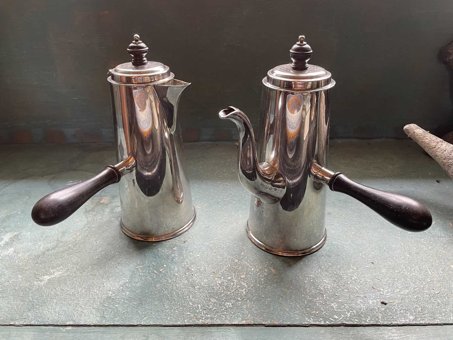 Lot 147 - An early Georgian style silver plated coffee/chocolate pot and hot water jug.